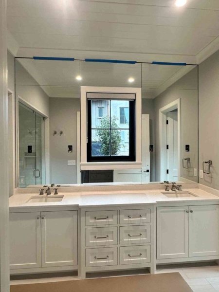 Mirrored wall over vanity with custom window shade